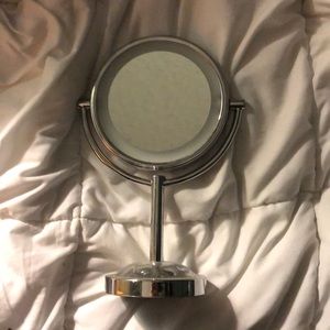 Dual sided mirror with magnification